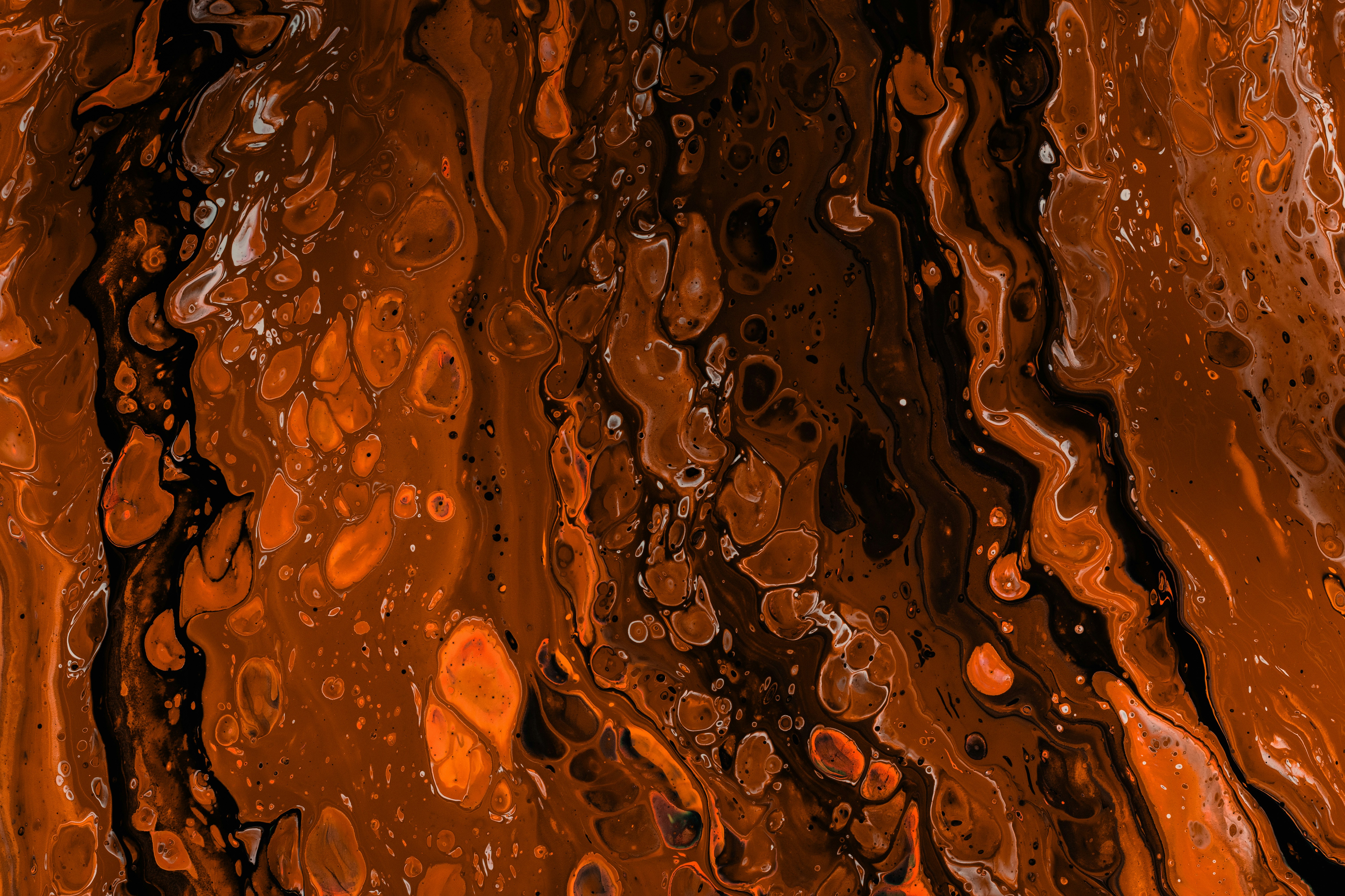 Abstract orange and black fluid art texture.